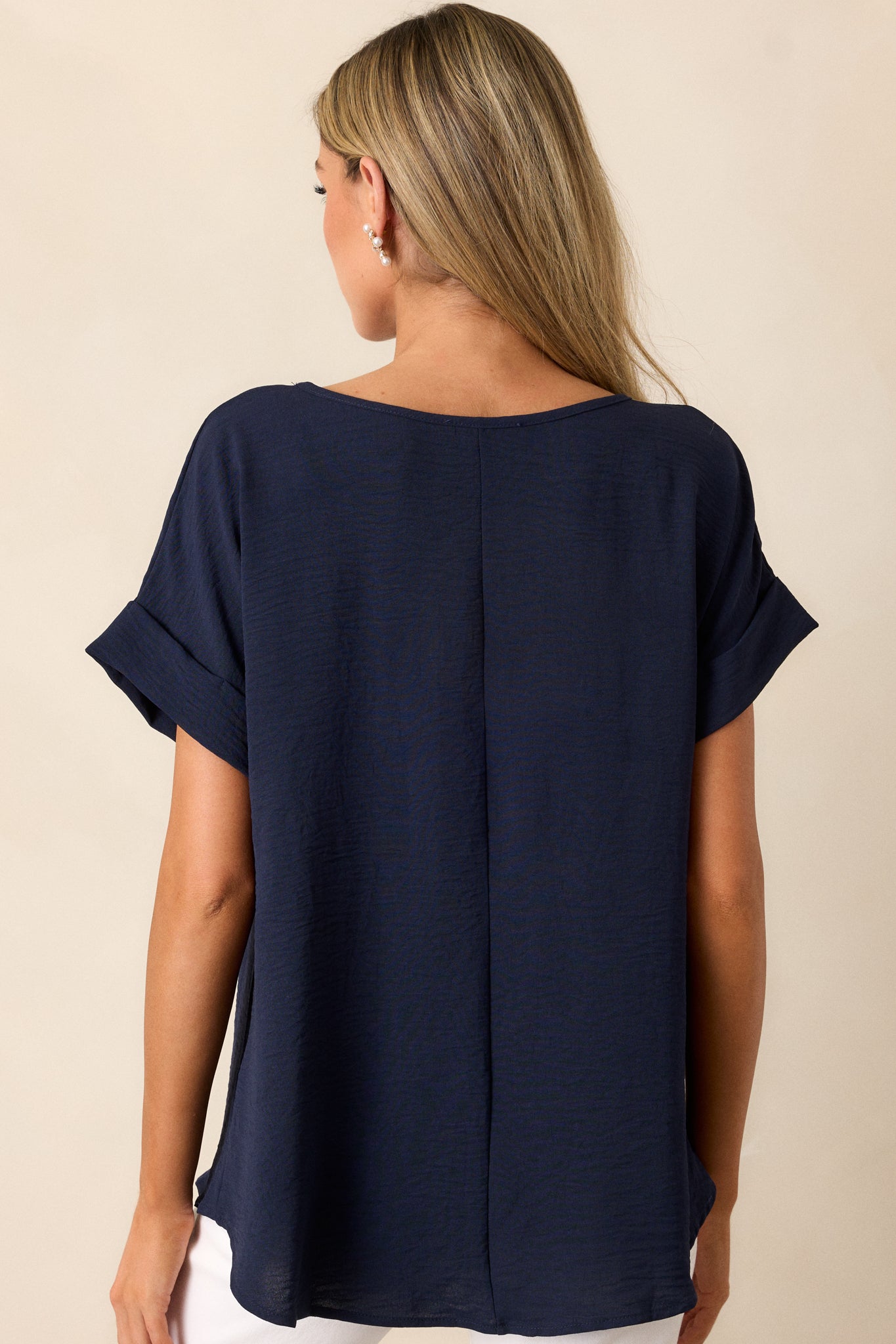 A rear view of the top, focusing on the intentional back seam detail that runs down the center of the garment.