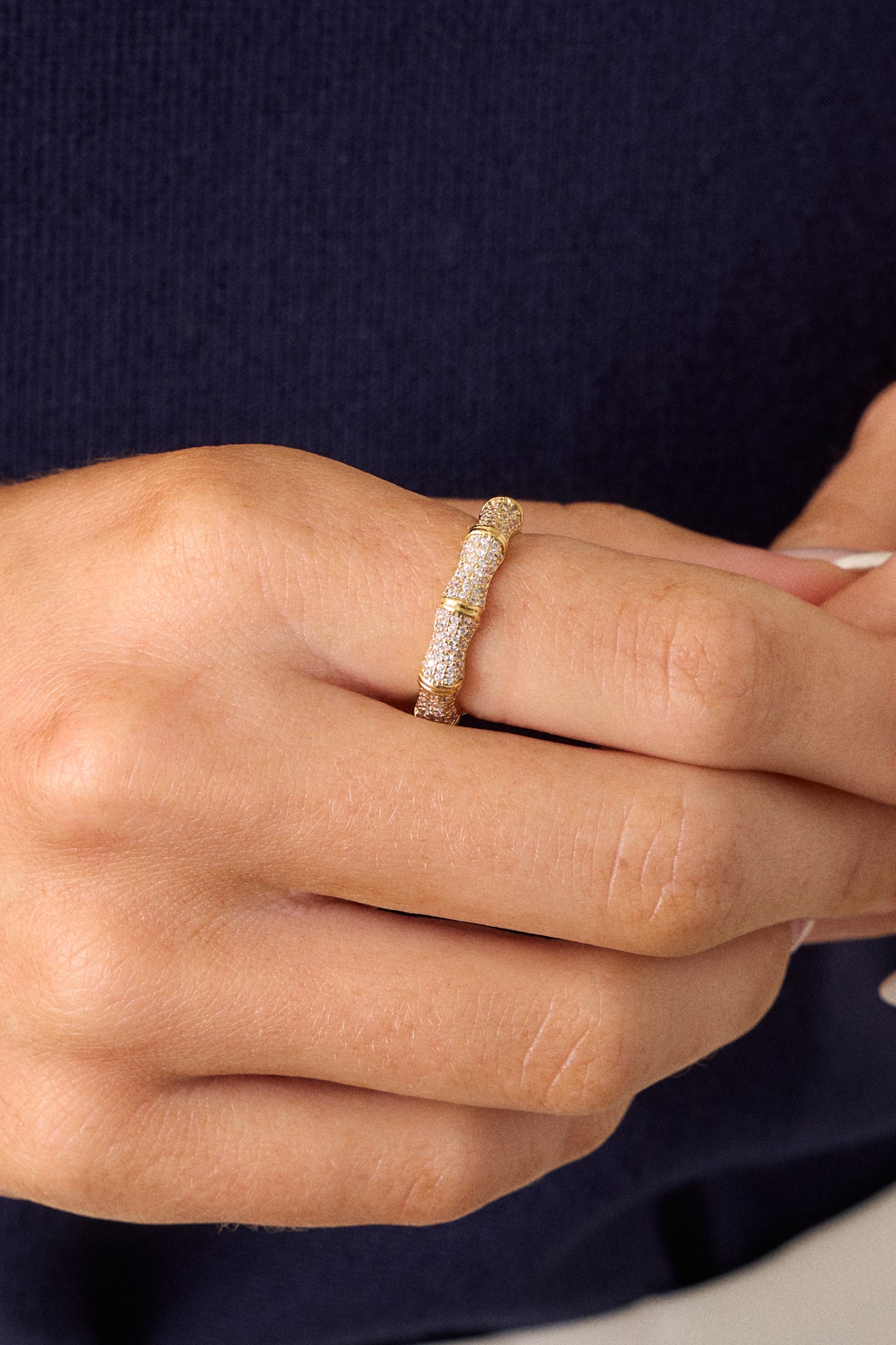 A close-up of the ring's surface, capturing the intricate details of the ridges and the shimmer of the rhinestones that enhance its luxurious appearance.