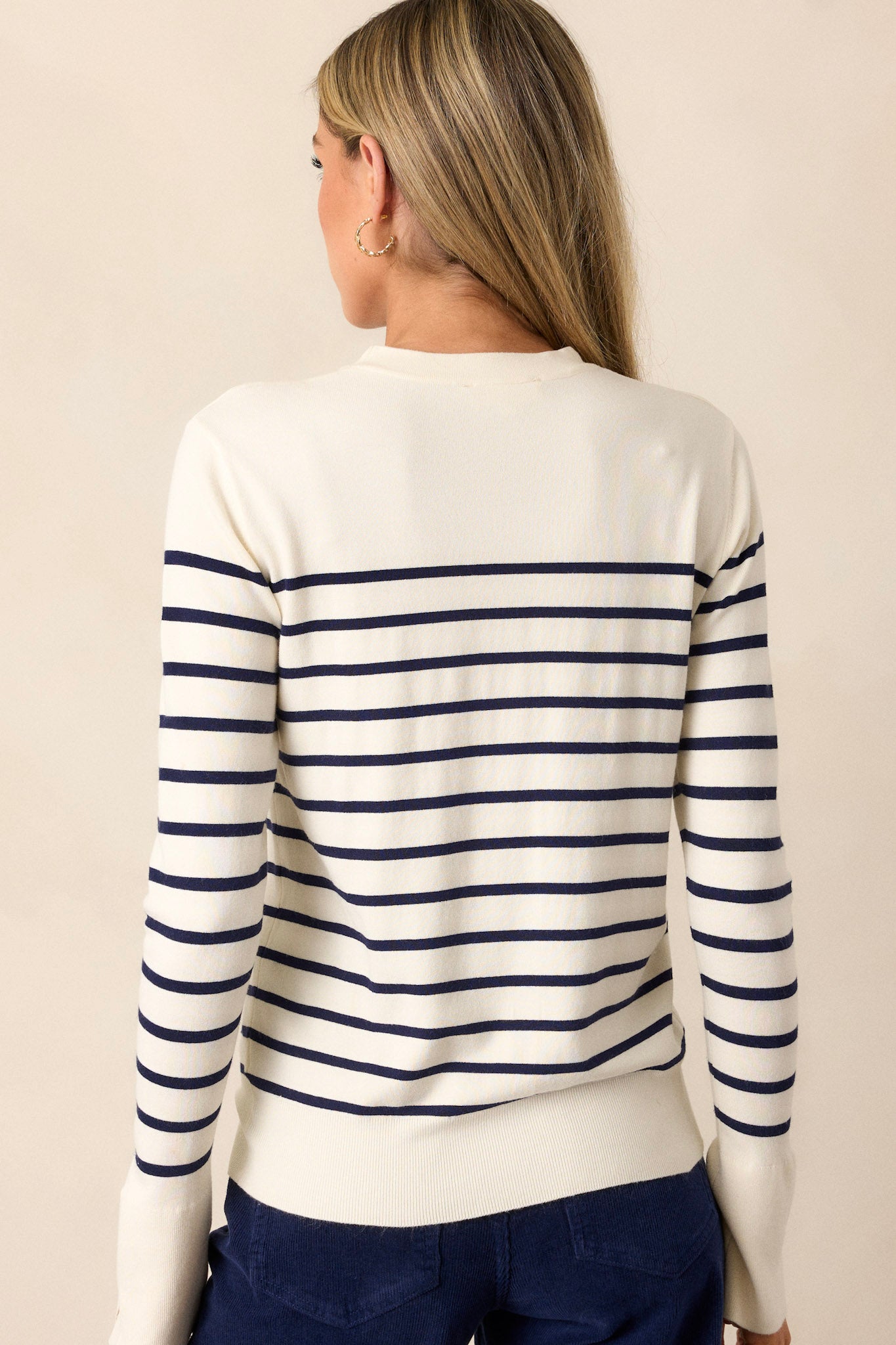 A view of the back of the navy stripe top, highlighting the simplicity of the design while showcasing the clean lines and ribbed texture.