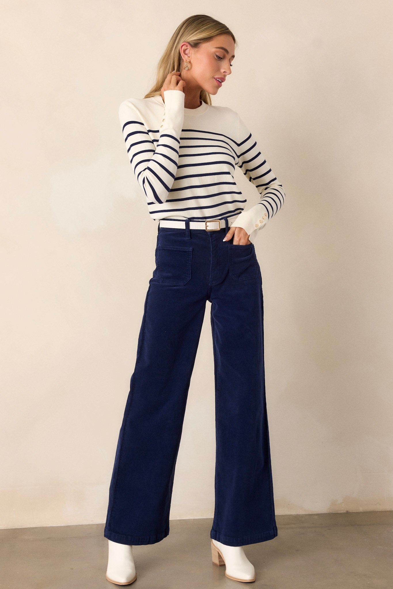 Front view of the navy corduroy jeans focusing on the front pockets and the straight leg design, highlighting the fit and fabric texture.