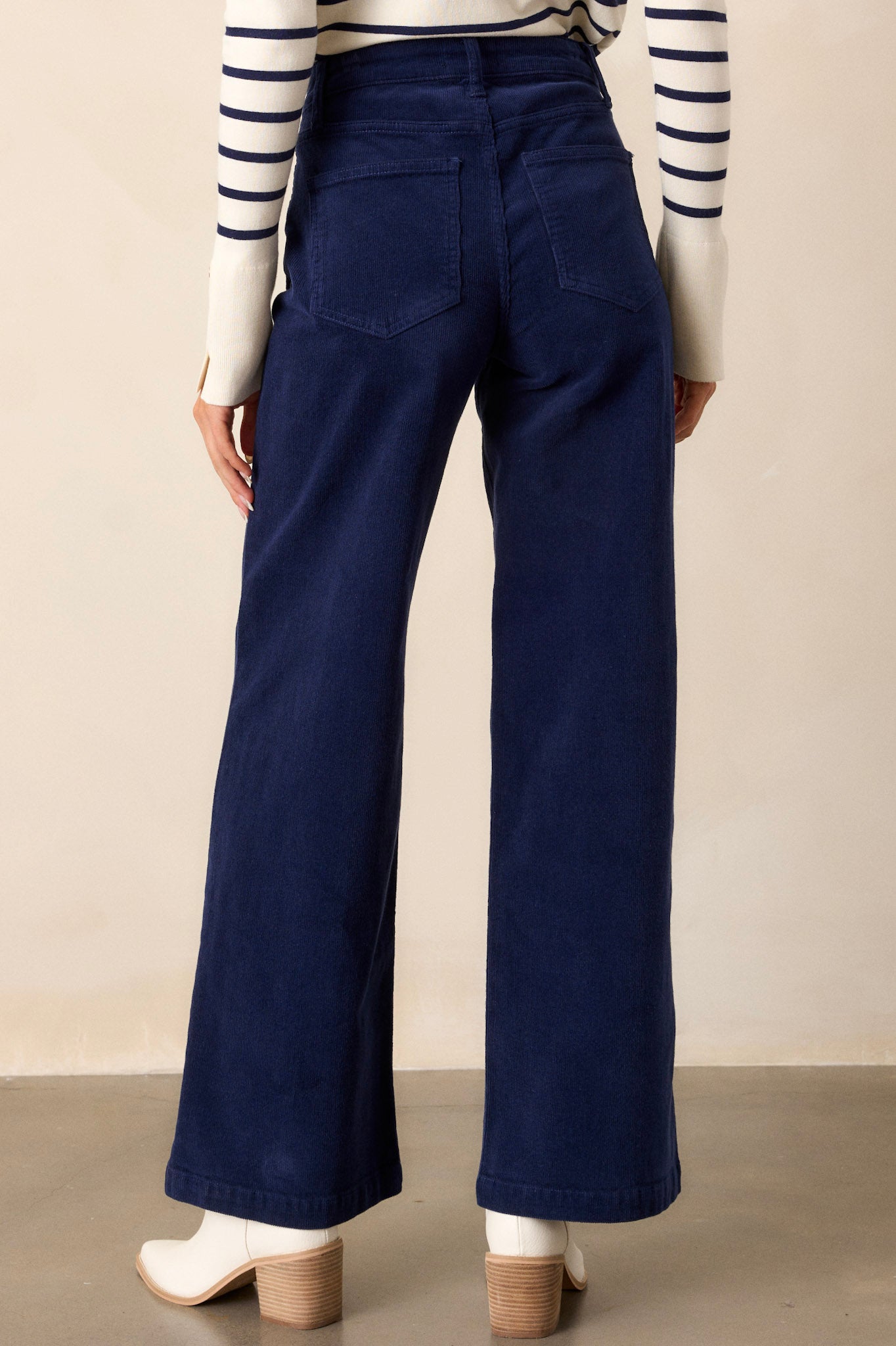 Back view of the navy corduroy jeans, showcasing the overall silhouette, back pockets, and high-waisted fit that flatters the shape.