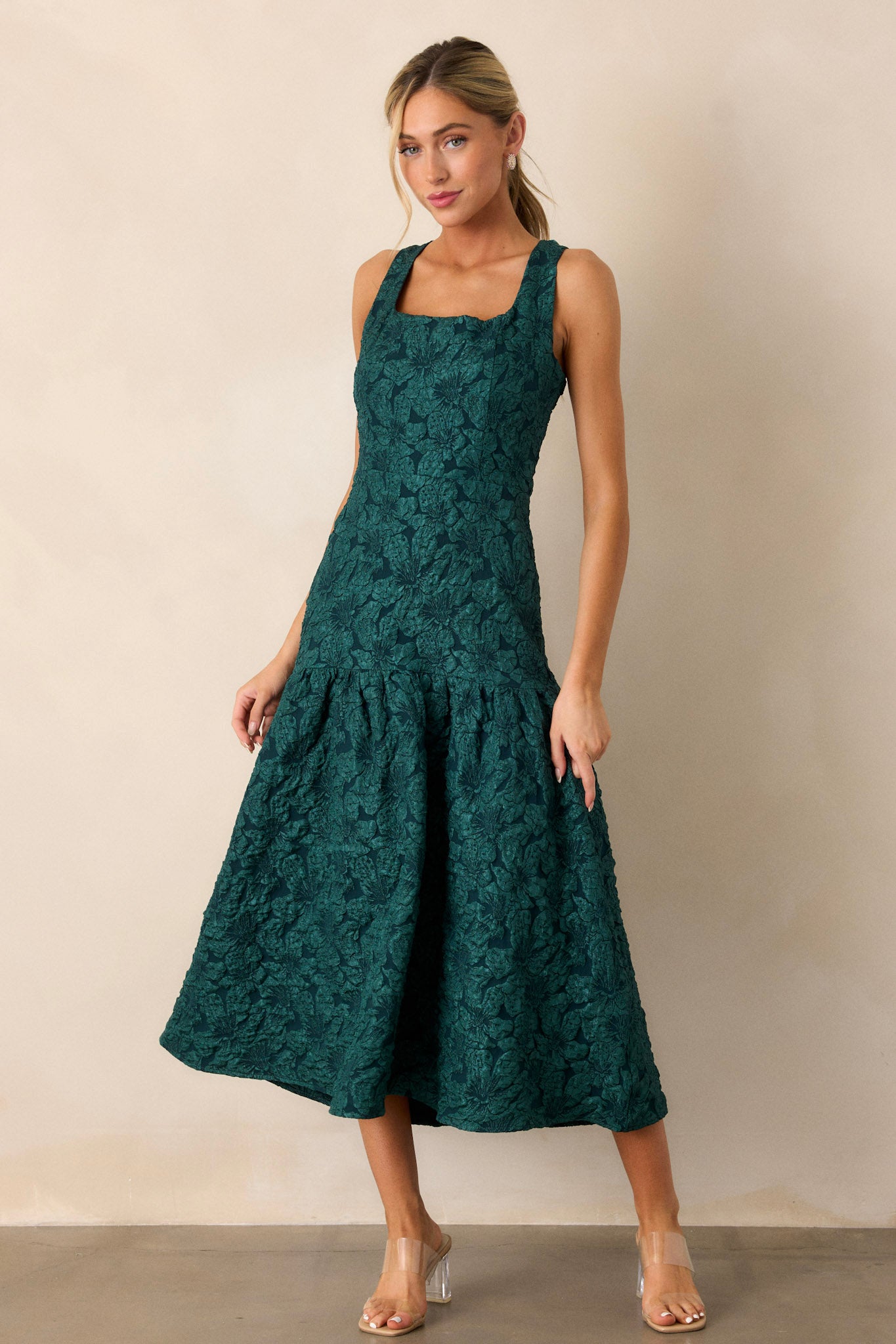 Front shot of the green dress, featuring the square neckline and the textured jacquard pattern across the top, with a drop waist visible.