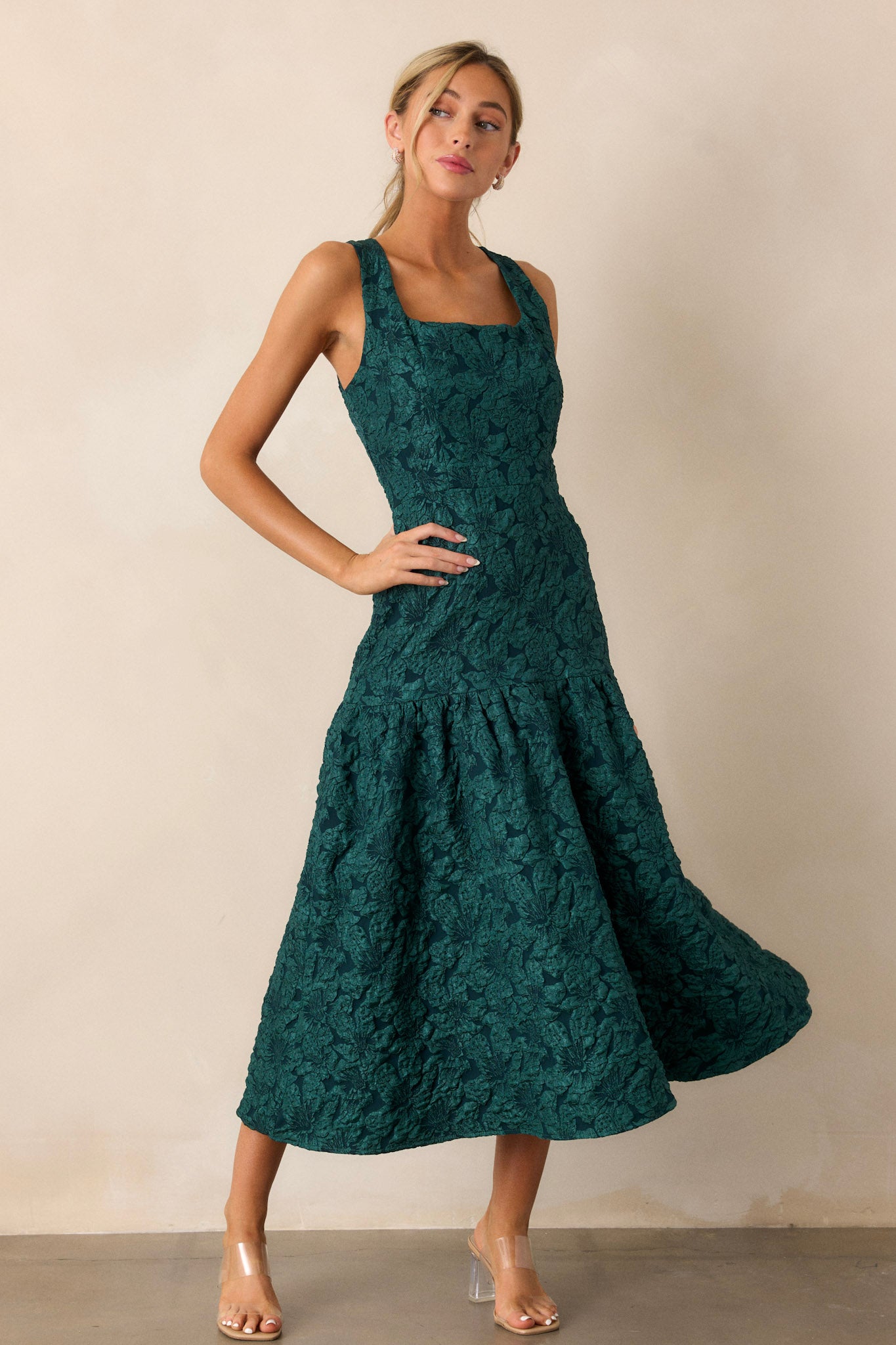 Full-body image showcasing the green dress’s top, emphasizing the sleeveless cut, square neckline, and the intricate jacquard detailing.