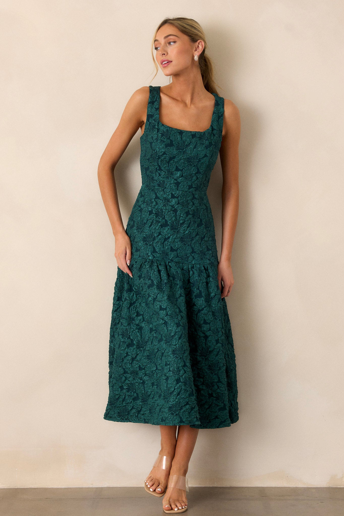 Full view of the green dress highlighting the sleeveless design, square neckline, and subtle jacquard pattern on the bodice.