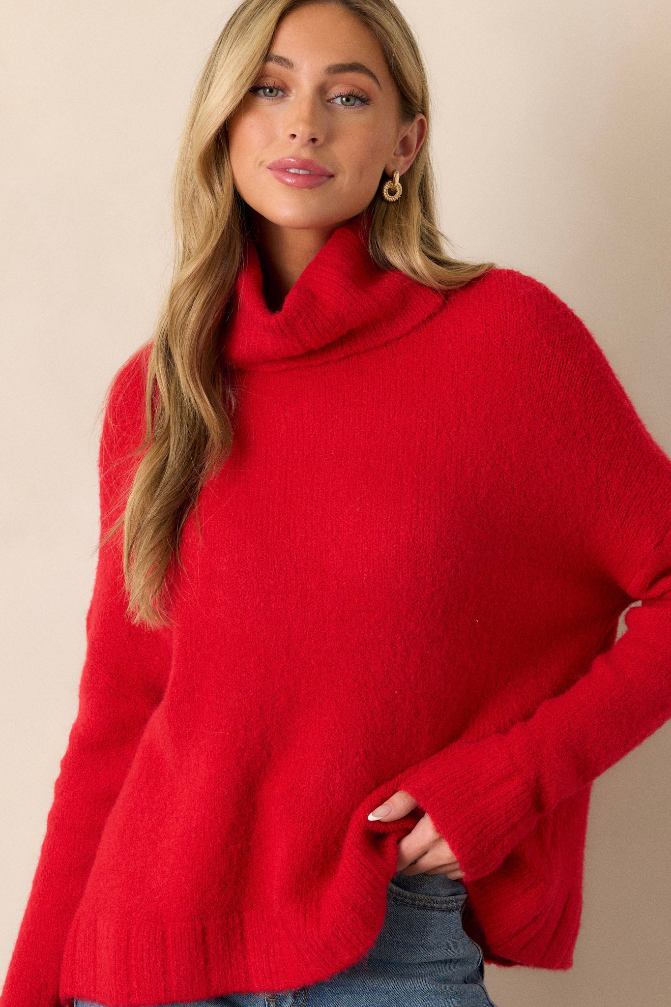 Full body view of this sweater that features a very light eyelash knit design and a turtle cowl neckline.