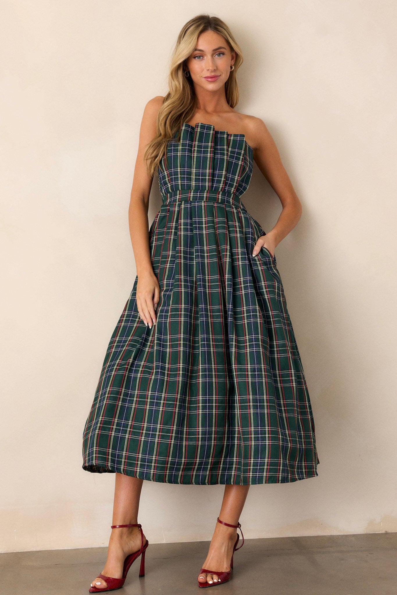 A front view capturing the entire dress, focusing on the vibrant plaid pattern and the flattering pleats that accentuate the waist.