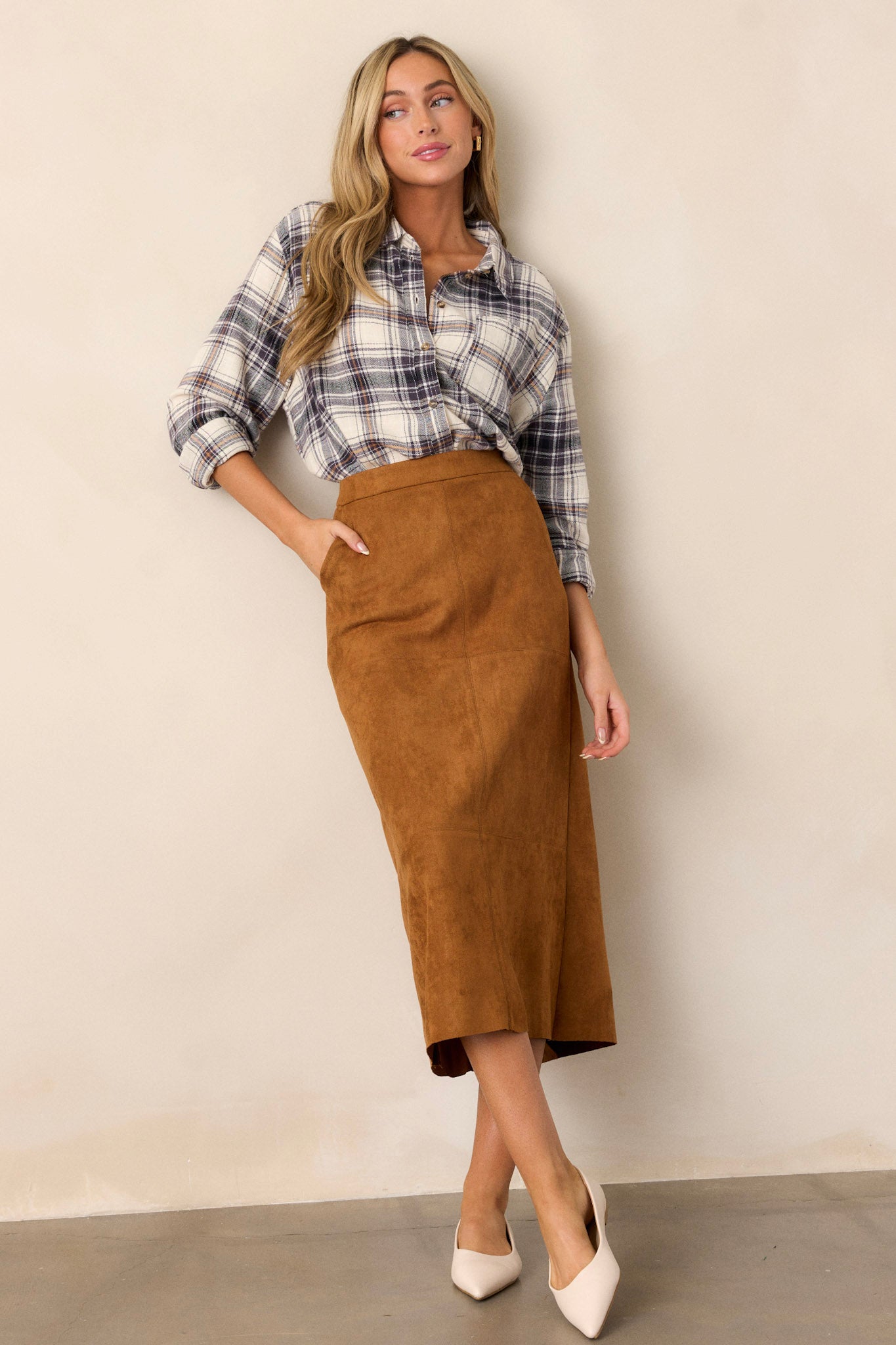 Full length view of the top featuring a collared neckline, buttons down the front, two functional front pockets, and a relaxed fit