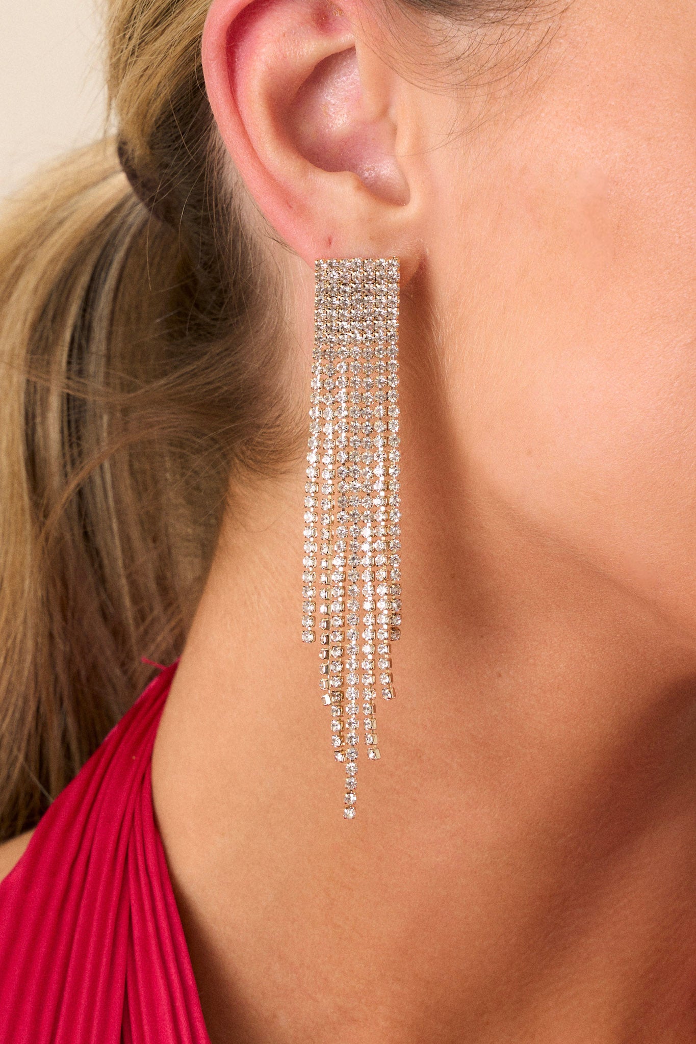 A close-up shot zooming in on the texture and shine of the rhinestones, showcasing the craftsmanship and the way they catch the light, enhancing the earrings' beauty.