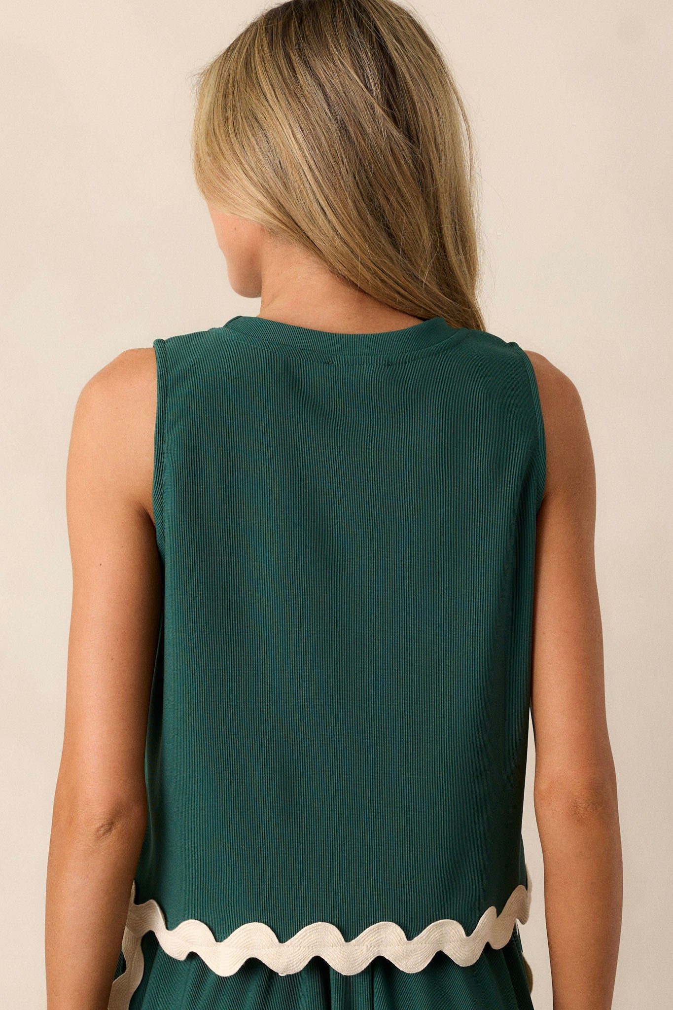 Back view of a hunter green tank top highlighting the overall fit, ribbed texture, and sleeveless design.