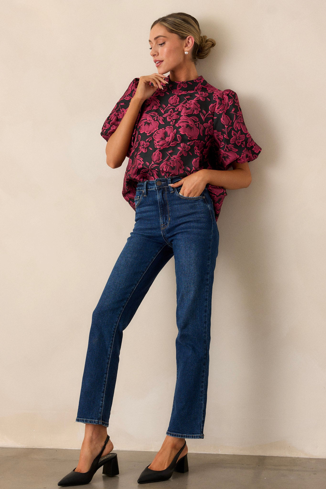 Full-length view of the dark fuchsia top, highlighting the puff sleeves, mock neckline, and the rich texture of the floral jacquard fabric.