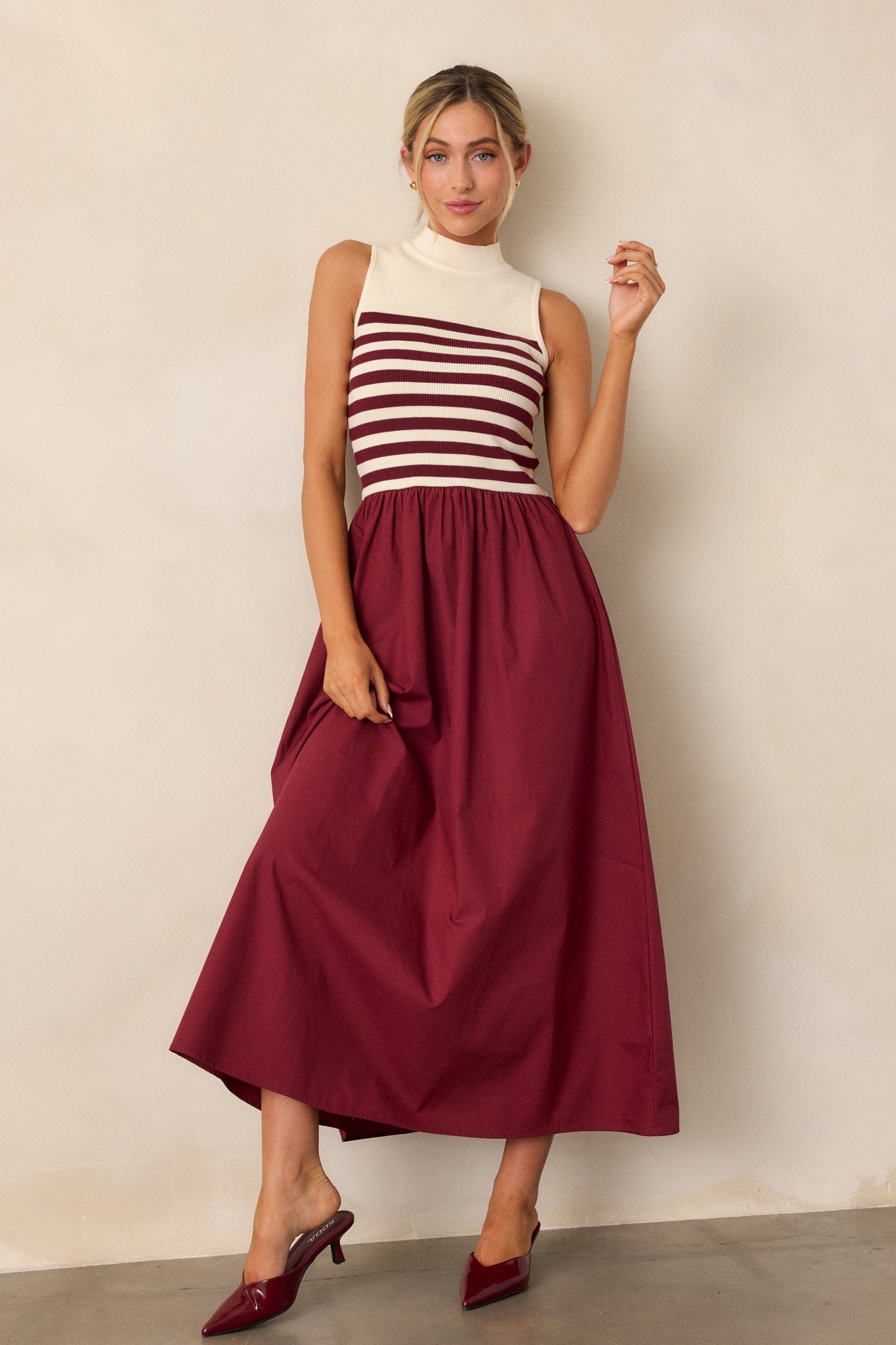 Sleeveless burgundy and white striped dress with a fitted bodice and a flared skirt.