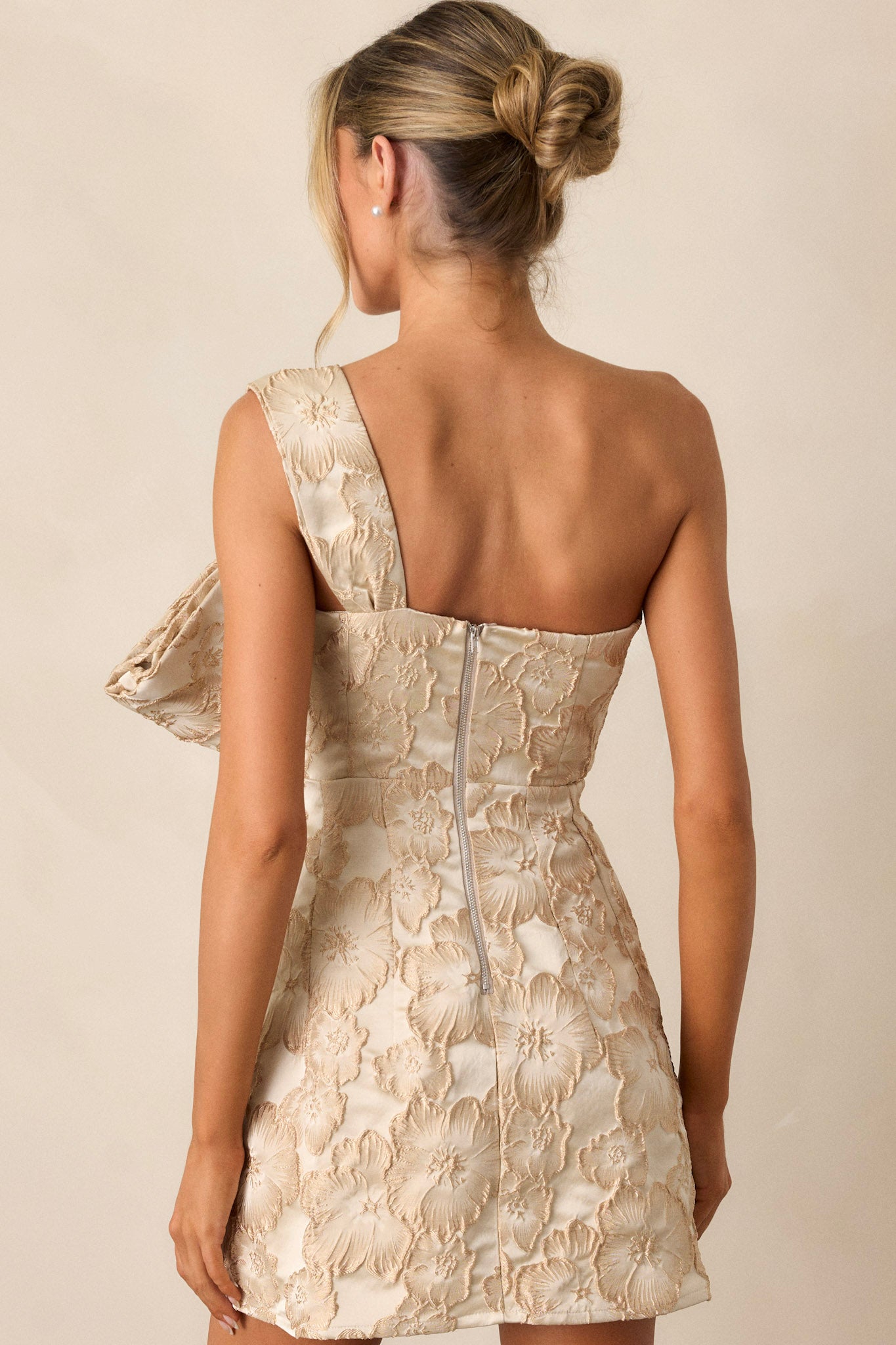 Detailed back view of the dress, capturing the elegant design elements and functionality of the back zipper, with the structured bow adding a unique touch.