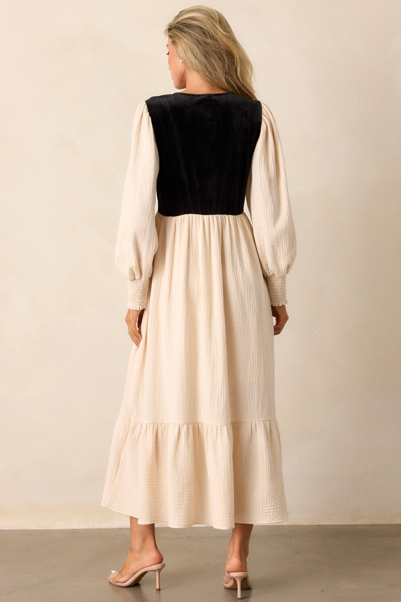 Back view of the dress, emphasizing the flowing nature of the tiered skirt and the overall elegant design, showcasing how the bodice complements the skirt.