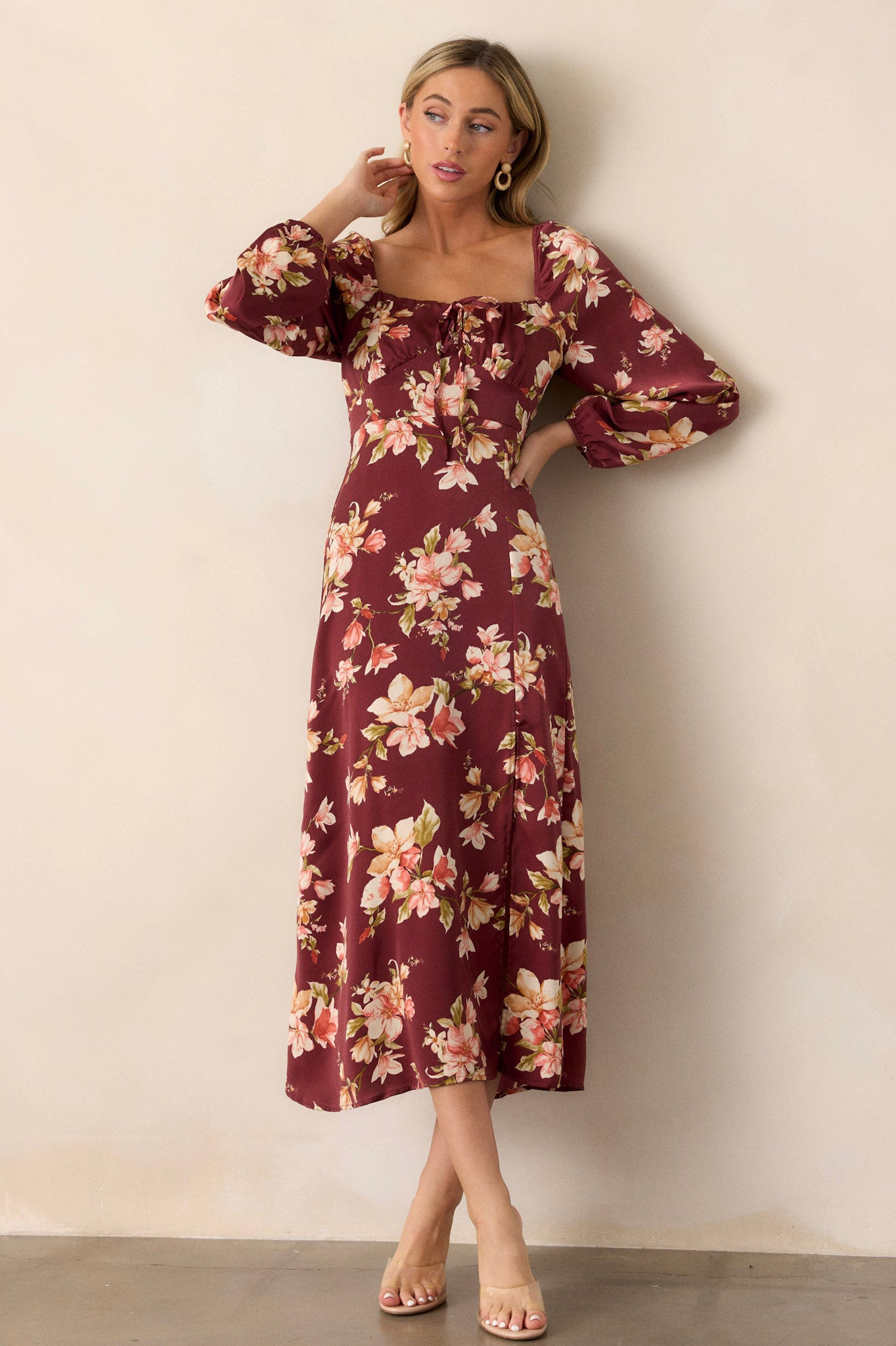 Full view of the burgundy floral dress featuring a squared neckline, showcasing its elegant silhouette and flowing design.
