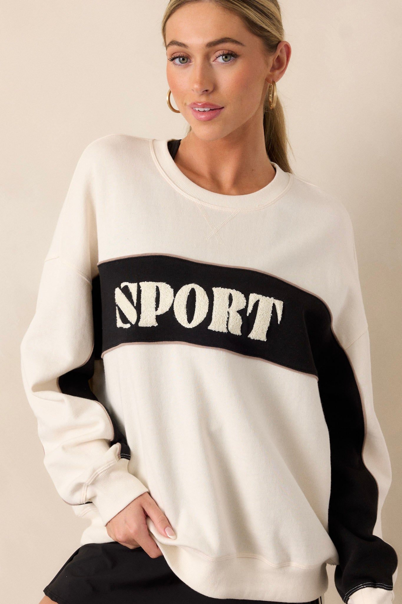 A cropped view focusing on the ribbed crew neck, showcasing the texture and design that adds structure to the neckline.