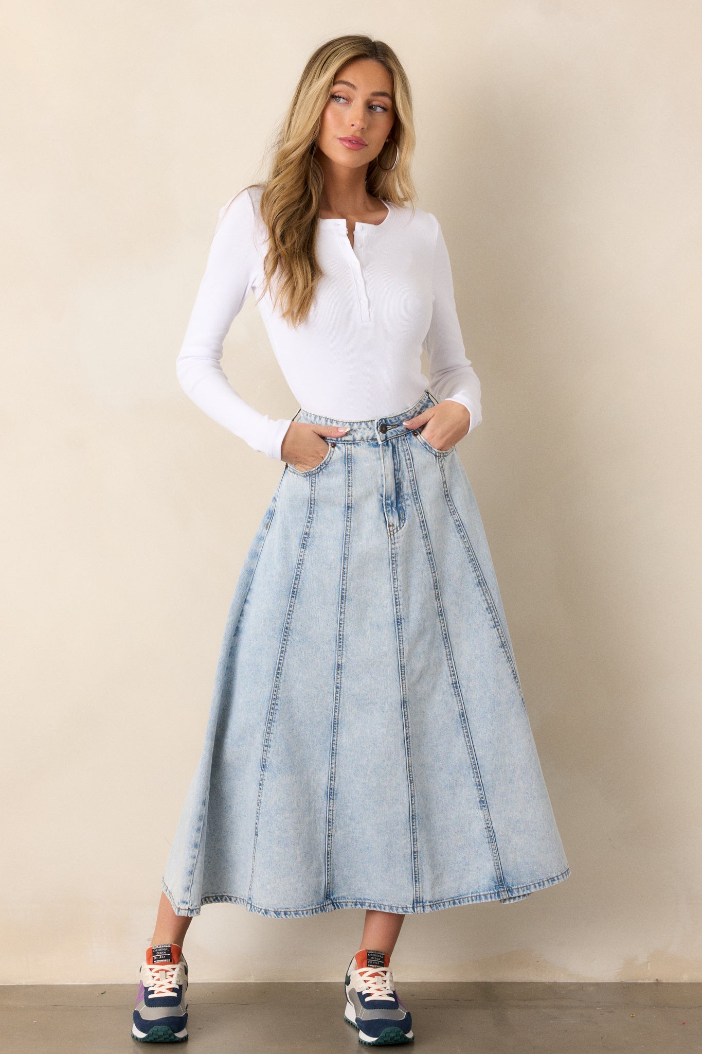 A complete shot of the skirt from the front, emphasizing the functional belt loops and the overall silhouette created by the denim fabric.