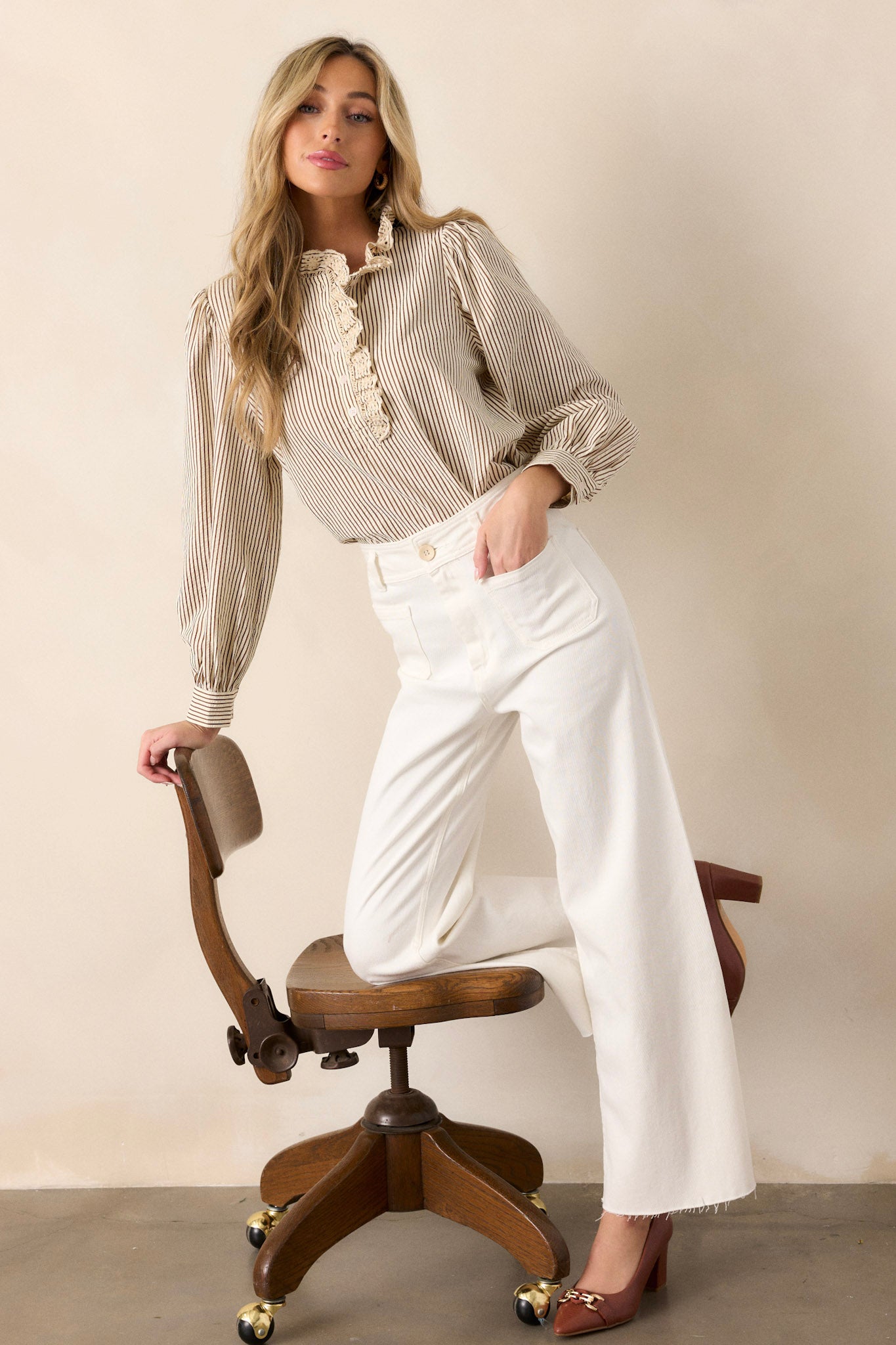 These ivory jeans feature a high waisted design, a button & zipper closure, belt loops, functional front & back pockets, a wide leg design, and a raw hemline