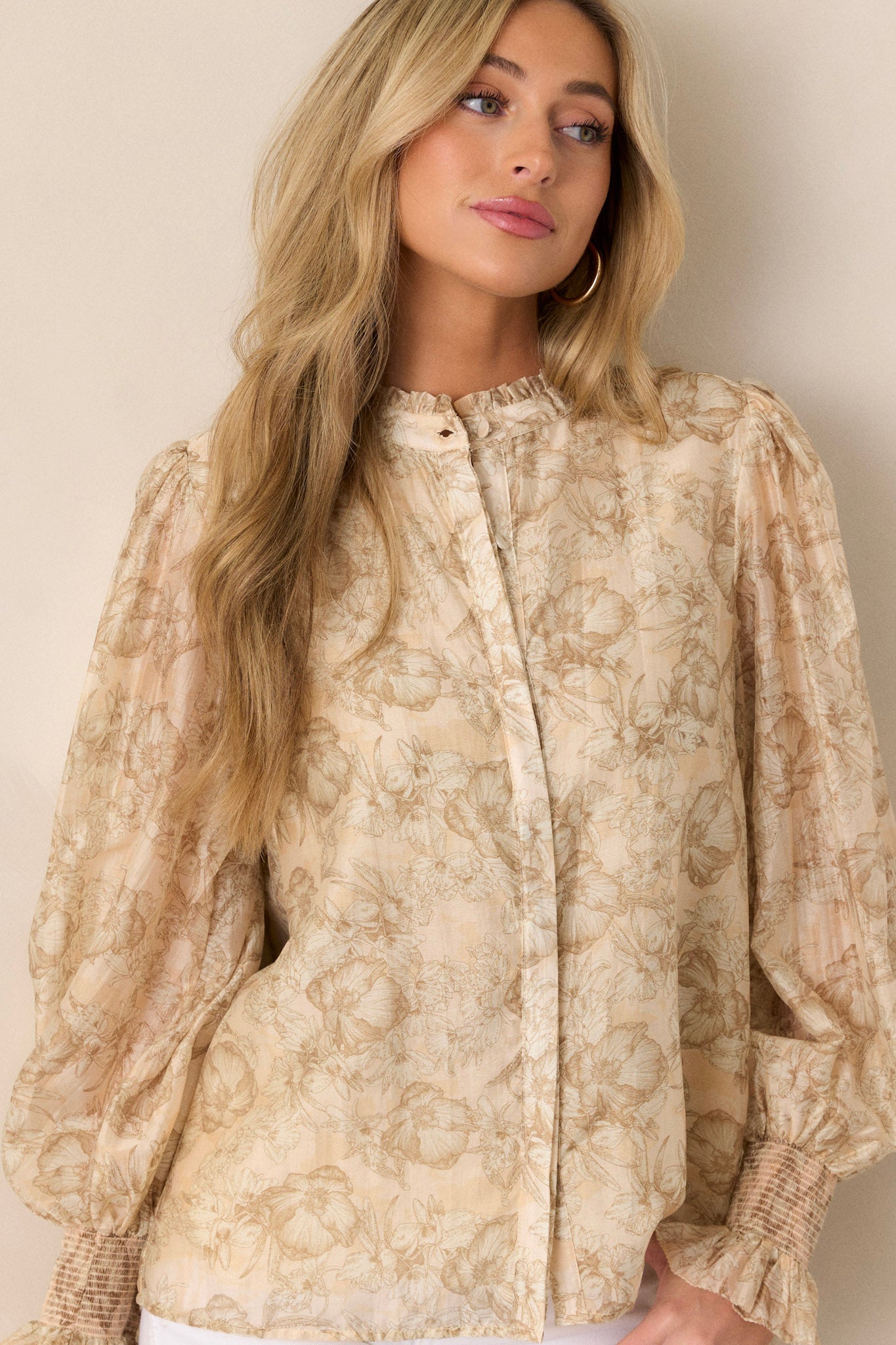 Cropped image of the top, highlighting the functional button front and the detailed floral pattern.