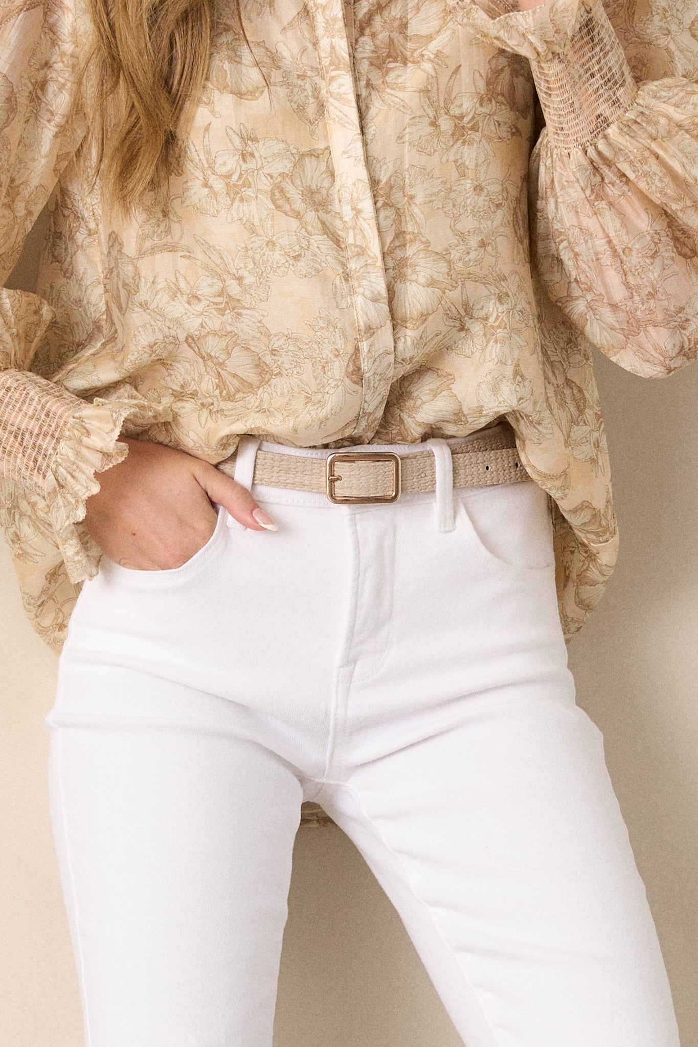 This beige belt feature a woven texture, a gold square buckle, and a single prong.