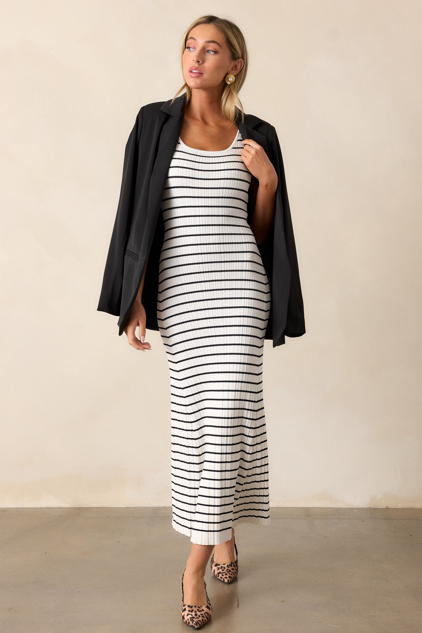 This white stripe dress features a scoop neckline, a classic stripe design, a soft ribbed design and a bodycon fit.