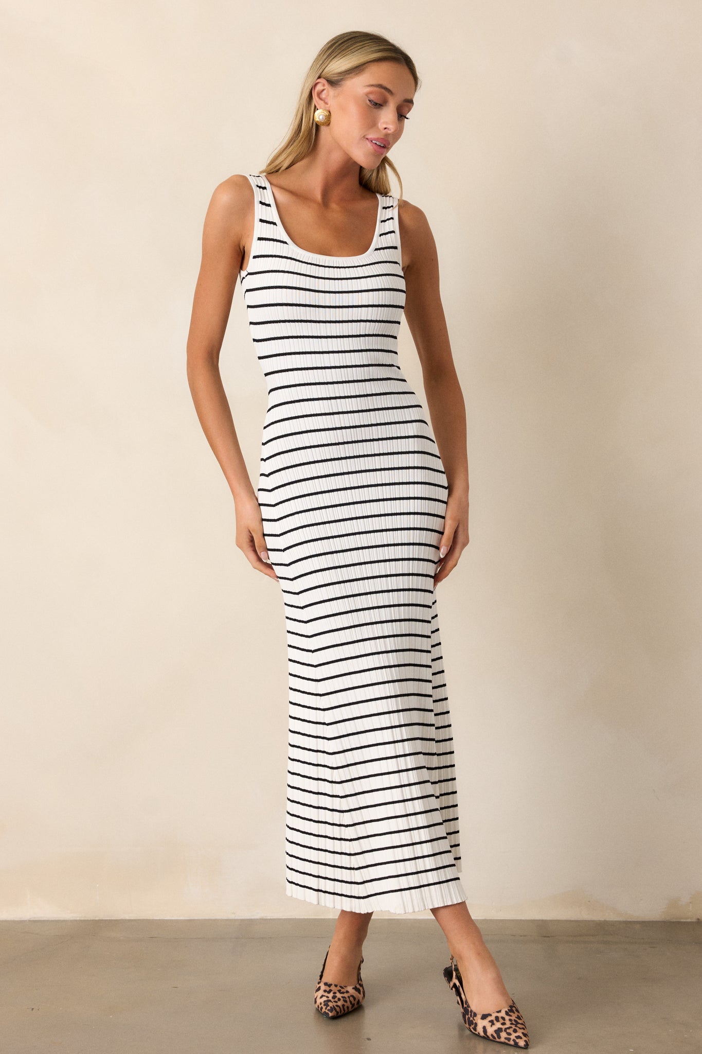 Front view of a white stripe dress featuring a scoop neckline, a classic stripe design, a soft ribbed texture, and a bodycon fit.