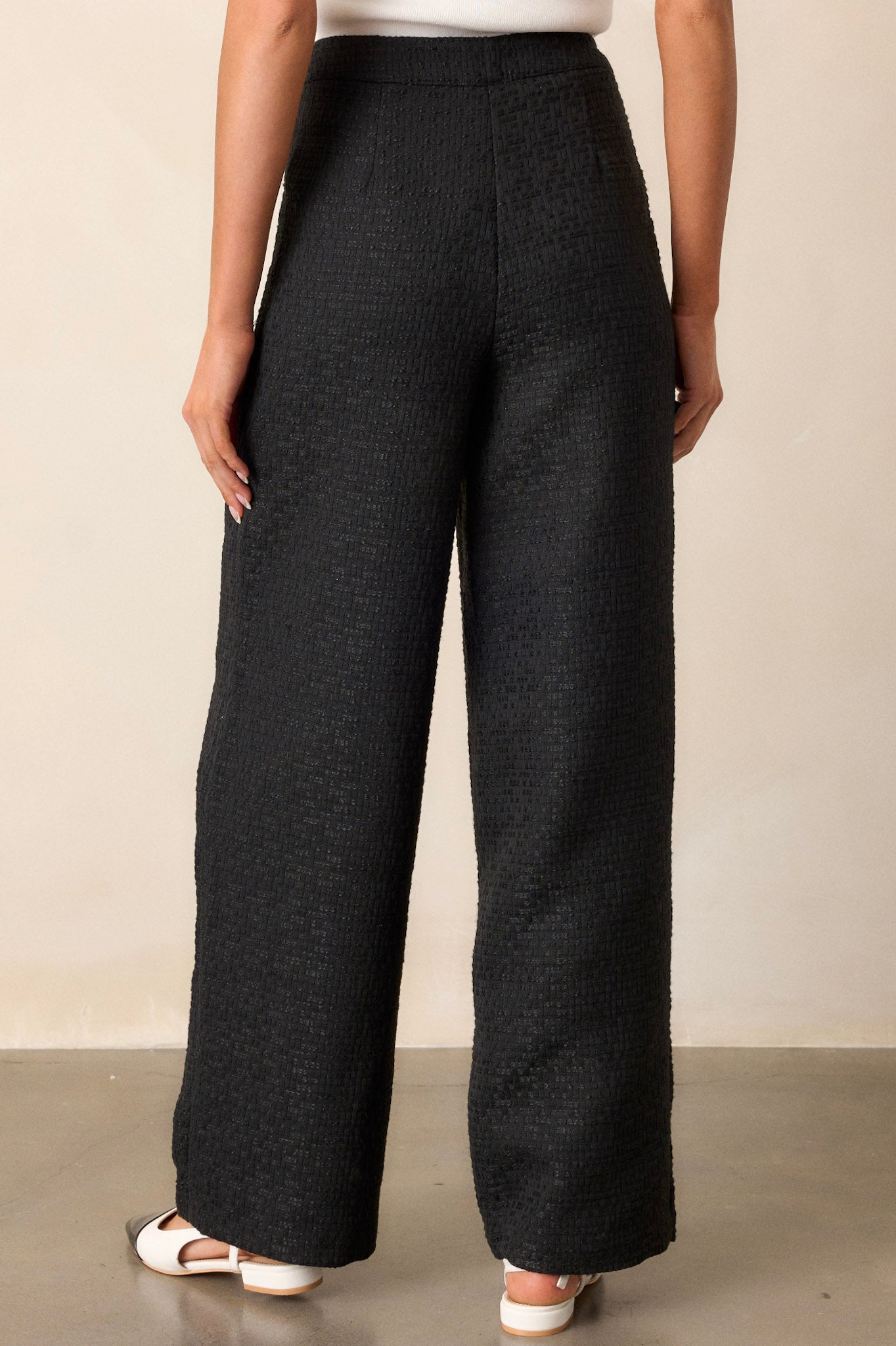 Back view of the pants, showcasing the overall fit and detailing without visible pockets.