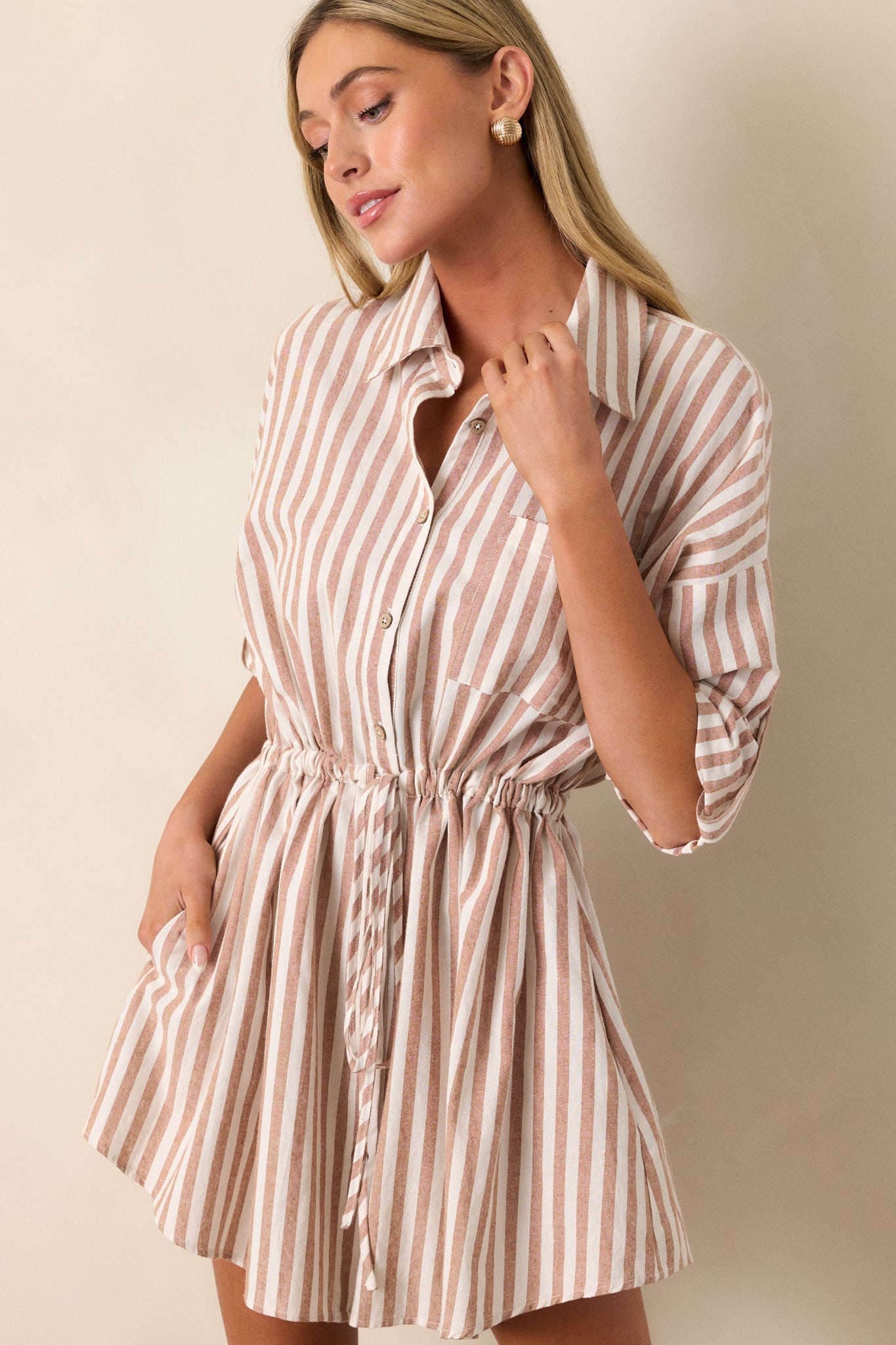 Cropped view of the hip pocket, capturing the pocket design against the striped fabric and emphasizing the dress’s functionality.