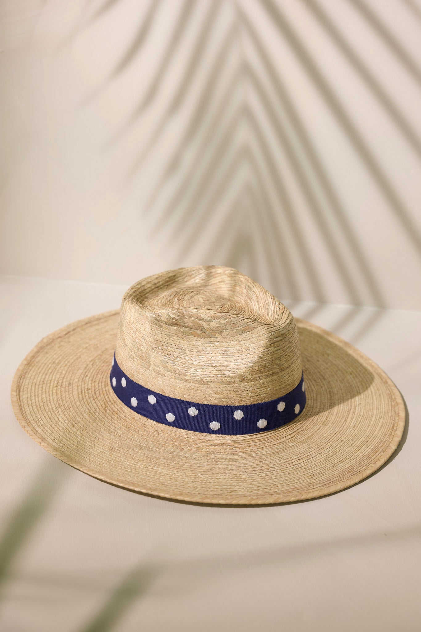 Front view of this Wendy hat features a navy, cotton woven band with white polka dots.