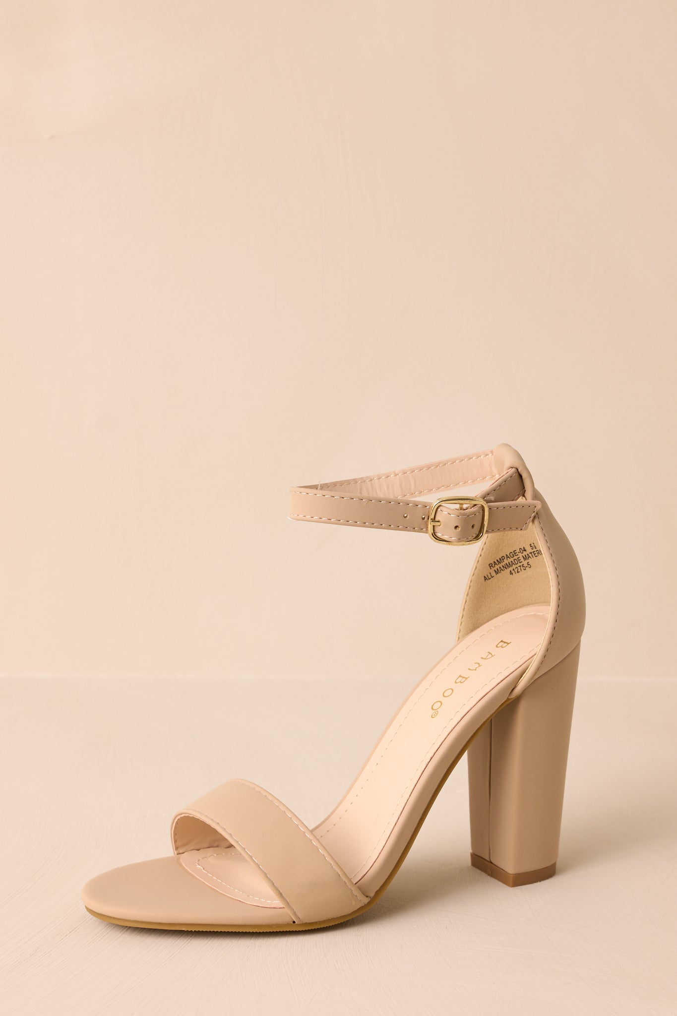 Close-up shot of the taupe heels focusing on the adjustable ankle strap and the smooth finish of the toe strap.