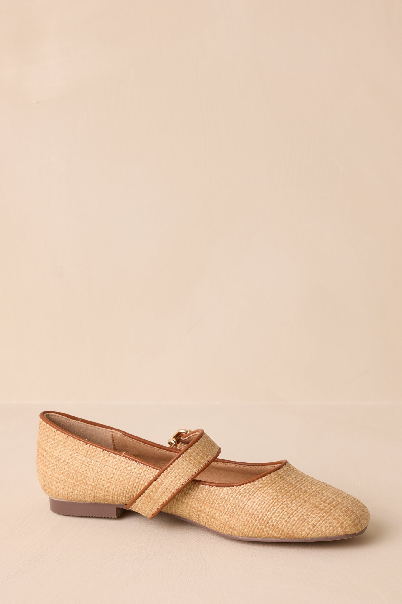 The side view of the natural flats, highlighting the clean lines and the square toe that define their elegant look.