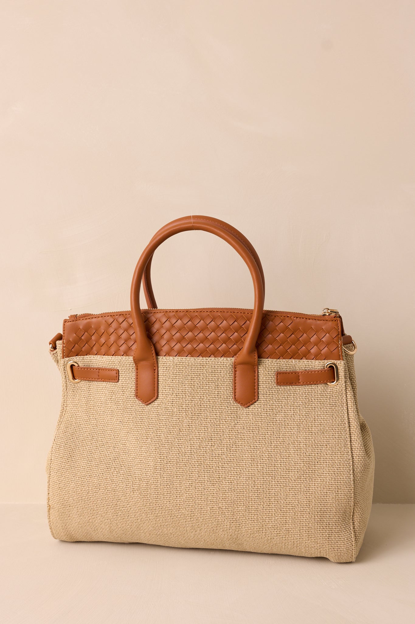 Back view of the tan structured tote bag highlighting the beige woven body, tan woven faux leather top, and gold hardware details