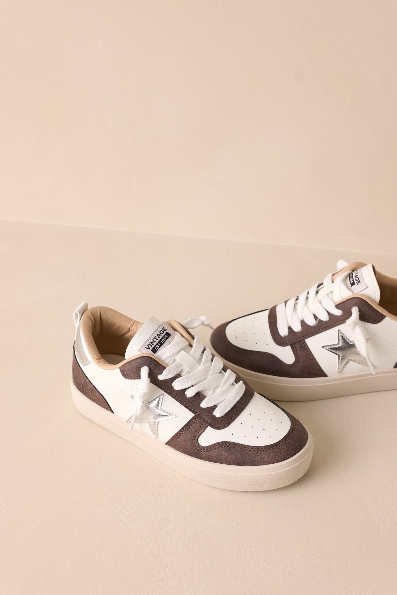 Top-down view of the brown sneaker, showcasing the laces and the rounded toe from above.