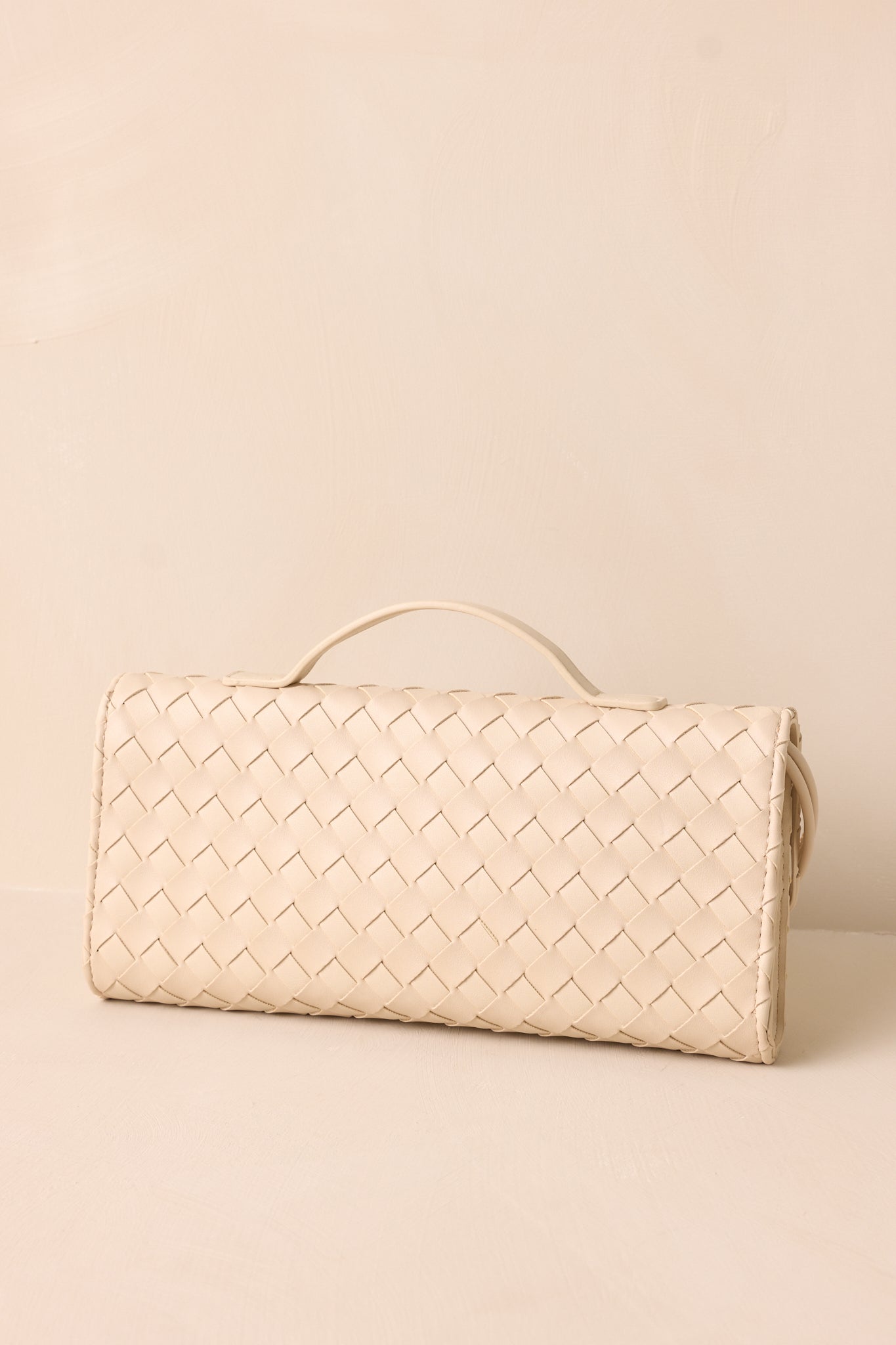 A back view of the ivory handbag, focusing on its clean and minimalistic rectangular design and smooth surface.