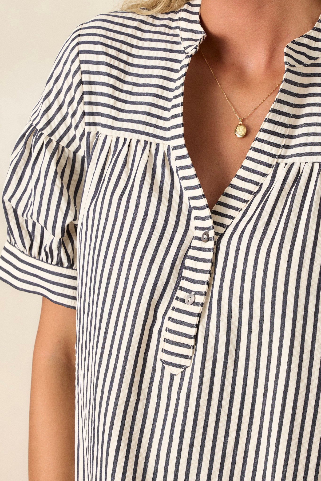 Detail shot of the buttons and stripe design on this mini shift dress.