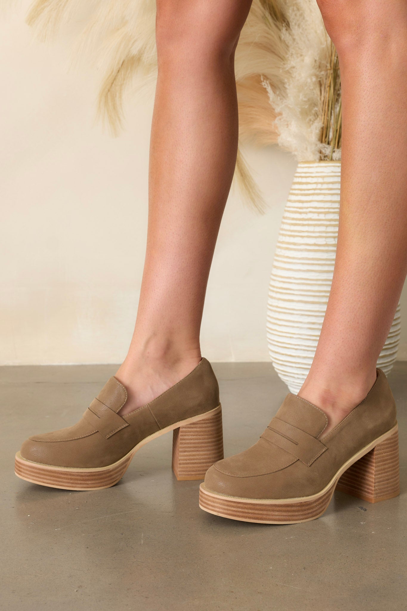 Side view of mocha loafers showcasing the platform sole, faux leather material, and chunky heel.