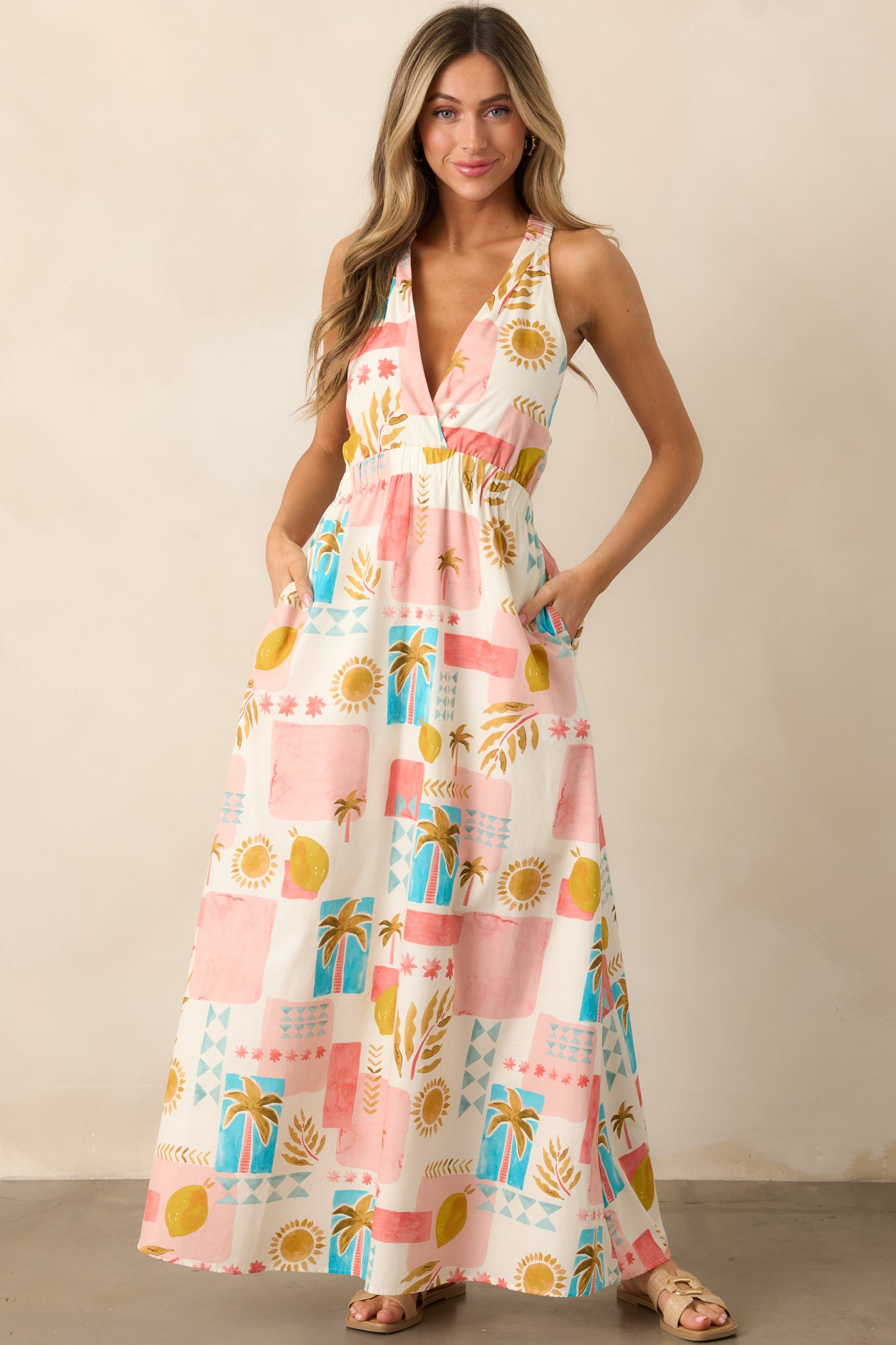 A full-length view of the pink dress showcasing the elastic bust detailing, tropical print, and the flow of the relaxed silhouette.