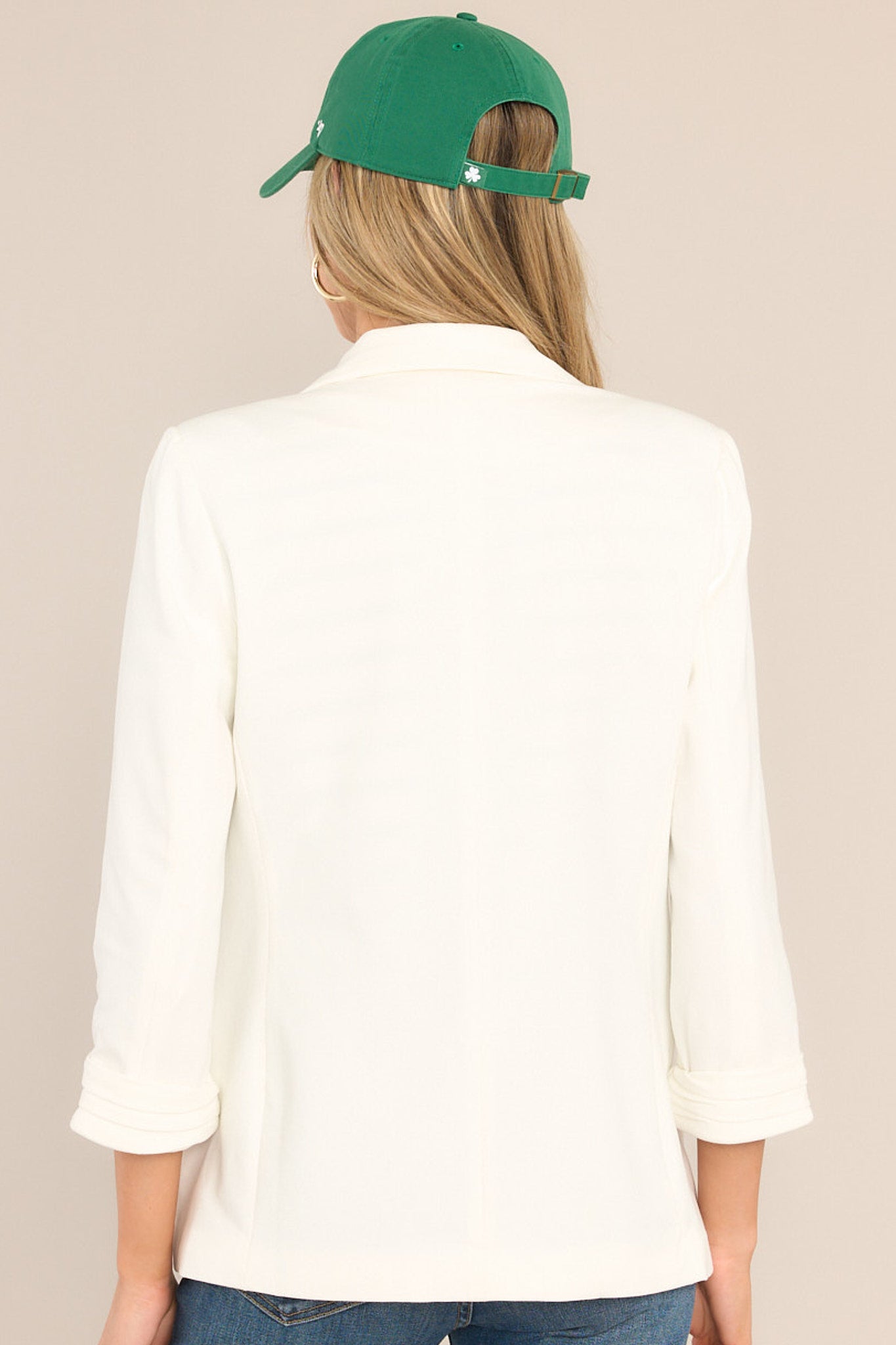 Back view of a blazer featuring shoulder padding, a straight cut, and a tailored fit.