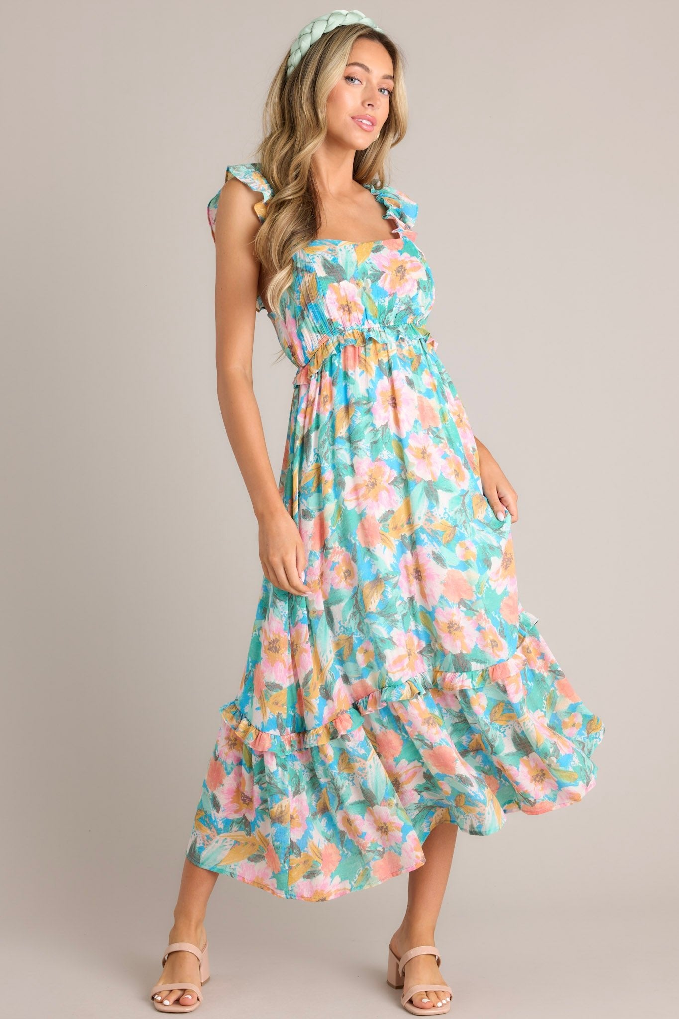 Angled full body view of this Floral square-neck dress with elastic sleeves, smocked back, elastic waistband, and flowy skirt