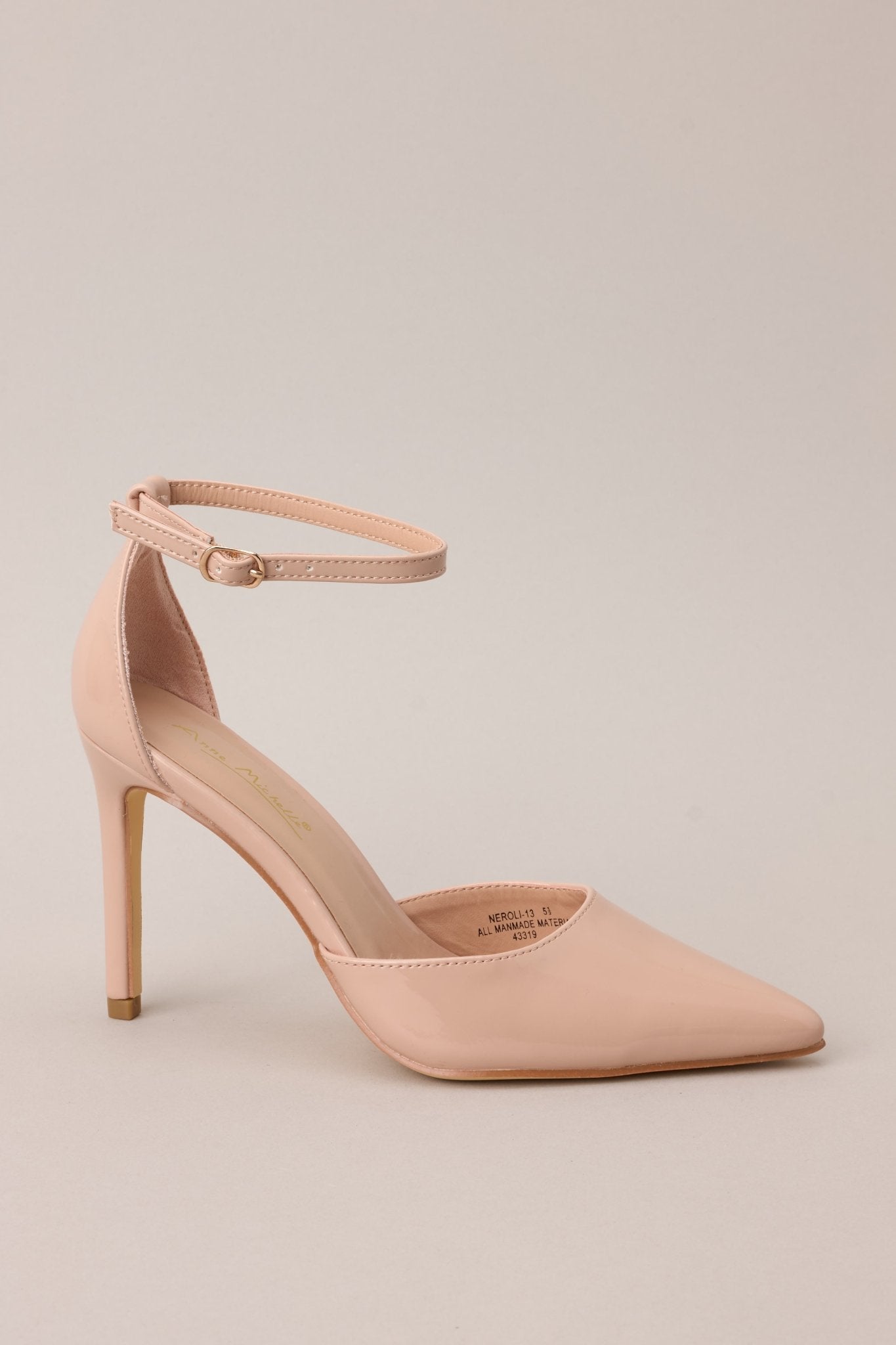  A side angle of the heels, highlighting the adjustable ankle strap ad the pointed toe.